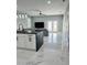 Open concept kitchen with marble floors, white cabinets, granite countertops, and stainless steel appliances at 5180 69Th N Ave, Pinellas Park, FL 33781