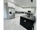 Bright kitchen with white cabinets, stainless steel appliances, granite counters, and large center island at 5180 69Th N Ave, Pinellas Park, FL 33781