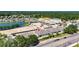 Aerial view shows new homes in a community near construction and a pond with convenient location near businesses, marked by a red pin at 5814 Stockport St, Riverview, FL 33578