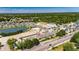 Aerial view shows new homes in a community near construction and a pond with convenient location near businesses, marked by a red pin at 5814 Stockport St, Riverview, FL 33578