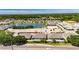 Aerial view shows new homes in a community near construction and a pond with convenient location near businesses, marked by a red pin at 5814 Stockport St, Riverview, FL 33578