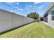 Lush green backyard with privacy fence and screened-in patio at 5814 Stockport St, Riverview, FL 33578