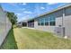 Spacious backyard featuring a green lawn and partial view of the property at 5814 Stockport St, Riverview, FL 33578