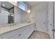 Bathroom featuring double sinks, white cabinets, a large mirror, and a framed shower with a glass door at 5814 Stockport St, Riverview, FL 33578