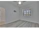 Bright bedroom featuring stylish gray wood-look floors and plantation shutters at 5814 Stockport St, Riverview, FL 33578