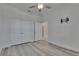 Bedroom with gray wood-look floors, white walls, and double-door closet at 5814 Stockport St, Riverview, FL 33578