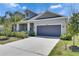 Beautiful home featuring a gray exterior, a two-car garage, and a well-maintained front yard at 5814 Stockport St, Riverview, FL 33578