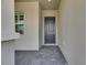 Inviting front entrance with a stylish gray door and brick walkway at 5814 Stockport St, Riverview, FL 33578