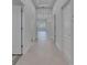 Hallway leading to a bright living area with lots of natural light and neutral paint at 5814 Stockport St, Riverview, FL 33578