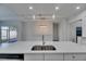 View of kitchen island and sink, looking towards a bright, open living space and a screened in porch at 5814 Stockport St, Riverview, FL 33578