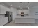 Bright kitchen with white cabinets, stainless steel appliances, and a large island with pendant lighting at 5814 Stockport St, Riverview, FL 33578