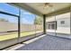 Screened lanai with brick pavers, ceiling fan, and views of the fenced backyard at 5814 Stockport St, Riverview, FL 33578