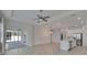Bright, open living area with tile flooring, ceiling fan, recessed lighting and access to a screened-in patio at 5814 Stockport St, Riverview, FL 33578
