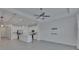Open-concept living room with a ceiling fan, recessed lights, and a modern kitchen with stainless steel appliances at 5814 Stockport St, Riverview, FL 33578
