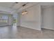 Open living area featuring modern light fixture, gray tile flooring and sliding glass door at 5814 Stockport St, Riverview, FL 33578