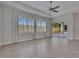 Bright living room with tile floor, a ceiling fan, large windows with shutters, and sliding glass doors at 5814 Stockport St, Riverview, FL 33578