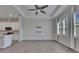 Open living area with modern kitchen, tile flooring, ceiling fan, and windows with shutters at 5814 Stockport St, Riverview, FL 33578