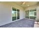 View of the covered patio featuring brick flooring and access to the backyard through sliding glass doors at 5814 Stockport St, Riverview, FL 33578