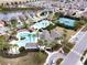 Aerial view showcasing community amenities including pools and a tennis court at 7869 Timberview Loop, Wesley Chapel, FL 33545