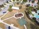 Community featuring a playground, picnic area, and basketball court in an aerial view at 7869 Timberview Loop, Wesley Chapel, FL 33545