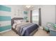 Relaxing bedroom boasts stylish decor, a large window, soft carpet, and modern furnishings at 7869 Timberview Loop, Wesley Chapel, FL 33545