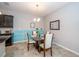 Cozy dining area with a glass table and comfortable seating for four people at 7869 Timberview Loop, Wesley Chapel, FL 33545