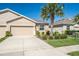 Charming single-Gathering home showcasing a well-maintained lawn and a two-car garage at 7869 Timberview Loop, Wesley Chapel, FL 33545