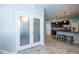 An open floor plan with tiled floors connects the kitchen with stainless steel appliances and barstool seating at 7869 Timberview Loop, Wesley Chapel, FL 33545