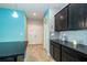 Modern kitchen featuring stainless steel appliances, black cabinetry and access to the Laundry at 7869 Timberview Loop, Wesley Chapel, FL 33545