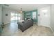 Bright living room with tile floors, a ceiling fan, and sliding glass doors to the outside patio at 7869 Timberview Loop, Wesley Chapel, FL 33545