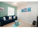 Cozy living room has comfortable seating, a ceiling fan, bright walls, and white trim at 7869 Timberview Loop, Wesley Chapel, FL 33545