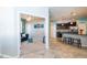 View from hallway into living room and kitchen of an open floor plan with tiled floors and carpet at 7869 Timberview Loop, Wesley Chapel, FL 33545