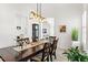 Spacious dining room featuring a large table and chairs, modern lighting, and ample natural light at 819 Islebay Dr, Apollo Beach, FL 33572