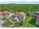 Expansive aerial view of the home, showcasing its screened lanai and well-maintained backyard with forest views at 8420 Dunham Station Dr, Tampa, FL 33647