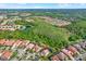 Community aerial view with water features and many houses, showing proximity to forested areas and ponds at 8420 Dunham Station Dr, Tampa, FL 33647