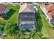 Aerial view of a screened pool and spa area with lush landscaping and a patio seating area at 8420 Dunham Station Dr, Tampa, FL 33647