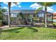 Expansive backyard featuring a screened-in pool area with outdoor seating and mature landscaping at 8420 Dunham Station Dr, Tampa, FL 33647
