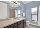 Classic bathroom featuring single vanity, walk-in shower, and frosted window for privacy at 8420 Dunham Station Dr, Tampa, FL 33647
