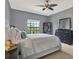 Calming bedroom features large window and classic dresser and nightstand set at 8420 Dunham Station Dr, Tampa, FL 33647