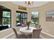 Cozy dining area with views of the pool area and spiral staircase through large windows at 8420 Dunham Station Dr, Tampa, FL 33647