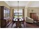 Spacious dining area with hardwood floors, stylish furniture, and large window with lots of natural light at 8420 Dunham Station Dr, Tampa, FL 33647