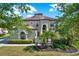Exterior view of the home with lush landscaping, mature trees and a charming facade at 8420 Dunham Station Dr, Tampa, FL 33647