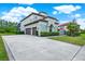 Beautiful stucco home with a tile roof, two-car garage, and well-maintained lawn at 8420 Dunham Station Dr, Tampa, FL 33647