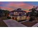 Charming two-story home with a terracotta roof, a spacious three car garage and a lush green lawn at 8420 Dunham Station Dr, Tampa, FL 33647