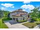 Stunning two-story home with a tile roof, lush landscaping, and a spacious three-car garage at 8420 Dunham Station Dr, Tampa, FL 33647