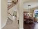 Welcoming foyer and dining area offer hardwood floors, elegant lighting, and stairs to the upper level at 8420 Dunham Station Dr, Tampa, FL 33647