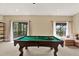Spacious game room features a pool table, large windows, and comfortable seating area at 8420 Dunham Station Dr, Tampa, FL 33647
