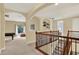 Open hallway with view to game room and staircase with wooden railing and metal balusters at 8420 Dunham Station Dr, Tampa, FL 33647