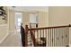 Hallway on the second level of a home with wood and wrought iron railings at 8420 Dunham Station Dr, Tampa, FL 33647