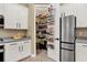 Kitchen with white cabinets, granite countertops, stainless steel refrigerator, and walk-in pantry at 8420 Dunham Station Dr, Tampa, FL 33647